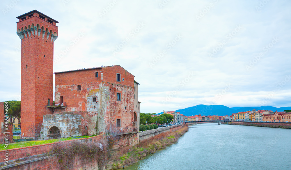 The Guelph Tower and Medici Citadel on the Arno River in Pisa, Tuscany, Italy.