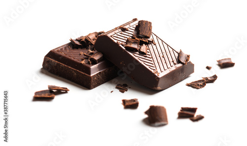 Curls and pieces of tasty chocolate on white table