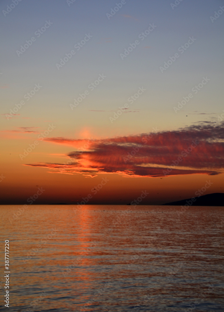 Romantic sunset over lake with nice clouds.
