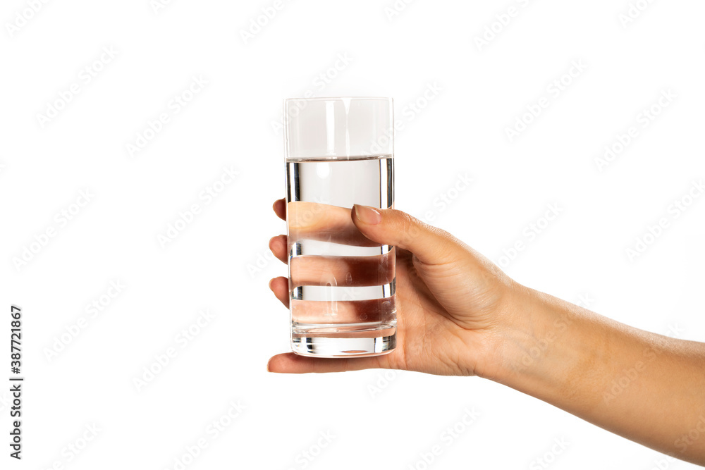 Hand holding a glass of water, isolated on white. Hand holding a glass of water, isolated on white.