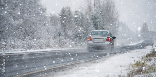The car is driving on a winter road in a blizzard   © scharfsinn86