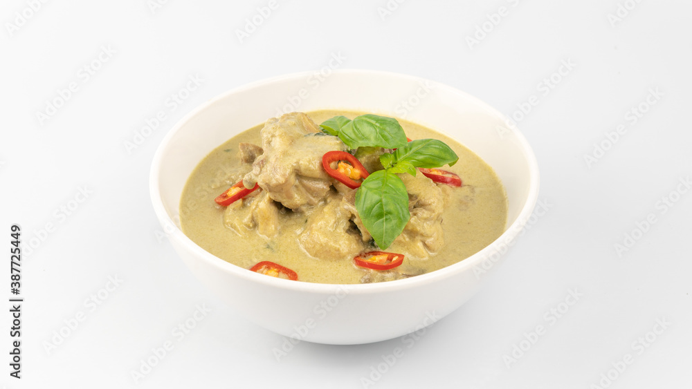 Traditional Thai cuisine, green curry chicken in white bowl over white background