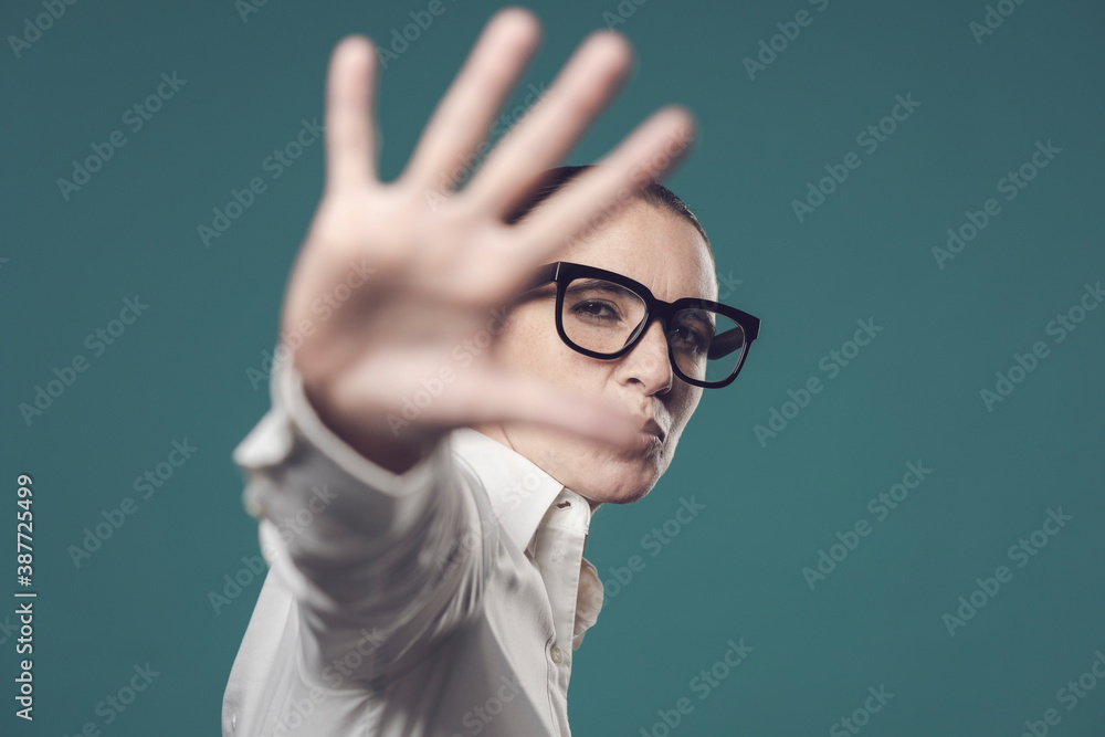 Confident woman making a stop gesture