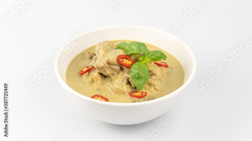 Traditional Thai cuisine, green curry chicken in white bowl over white background