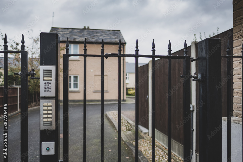 Shallow focus of an electronic keypad seen at the gated entrance to a private housing development. The area if for residents allocated parking. Shallow focus of an electronic keypad seen at the gated entrance to a private housing development. The area if for residents allocated parking.