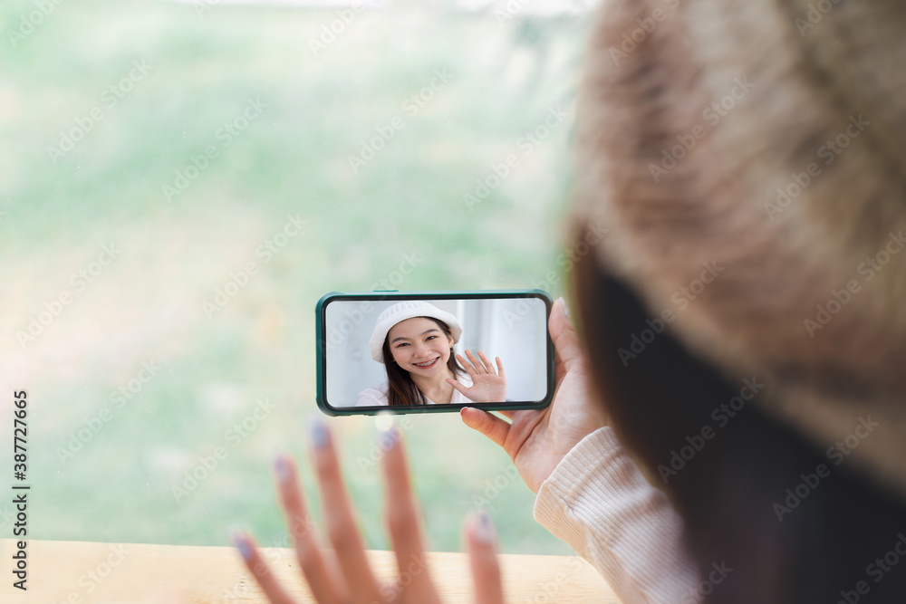Cropped image of woman video conferencing on smartphone mobile.