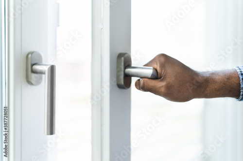 African American Man Opening Office Window