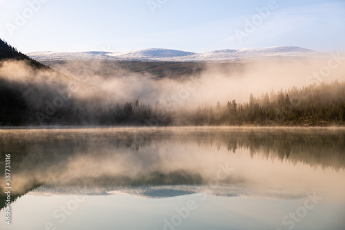 morning mist on the lake with mirror on the water