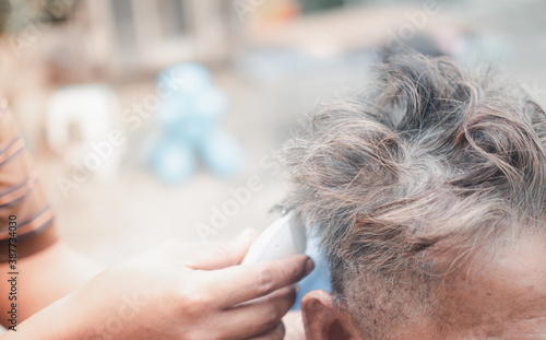 Elegant middle aged man getting haircut in home during Coronavirus outbreak