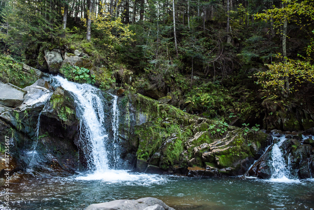 Rapid mountain river with a waterfall in the national park Rapid mountain river with a waterfall in the national park