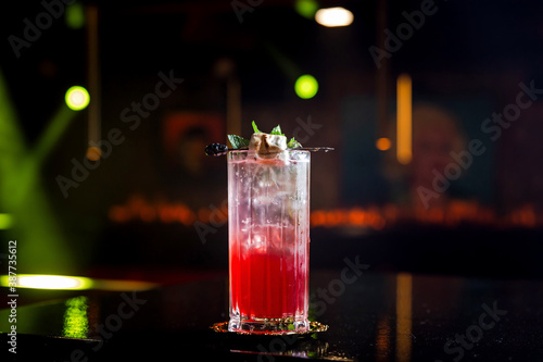 Cuadro en lienzo A layered red and transparent long drink cocktail in a collins highball glass, w