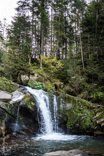 Waterfall on a mountain river in the autumn forest