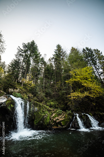 Rapid mountain river with a waterfall in the national park