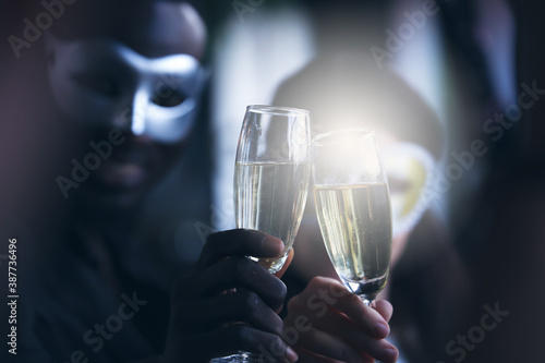 Business people or team or friend or colleague wear mask cover and drinking wine or champagne or alcohol in party after work, happy Christmas day or new year celebration