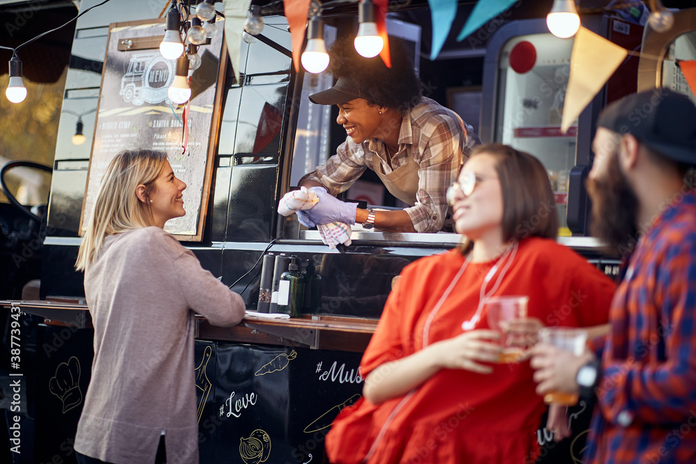 employee having conversation with a customer, smiling, with another couple standing by, talking employee having conversation with a customer, smiling, with another couple standing by, talking