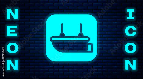 Glowing neon Lifeboat icon isolated on brick wall background. Vector.