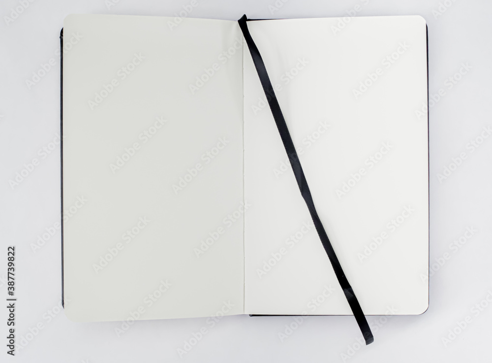 Unfold open notebook, book with blank white pages and black ribbon,  bookmark on light background. Top view. Sketchbook. Stock-Foto | Adobe Stock