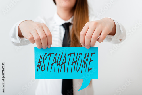 Conceptual hand writing showing Hashtag Stay at home. Concept meaning a trending label in social media related to the coronvirus outbreak Displaying different color notes for emphasizing content photo