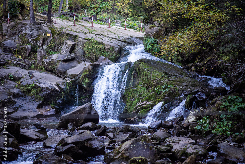 Rapid mountain river with a waterfall in the national park Rapid mountain river with a waterfall in the national park