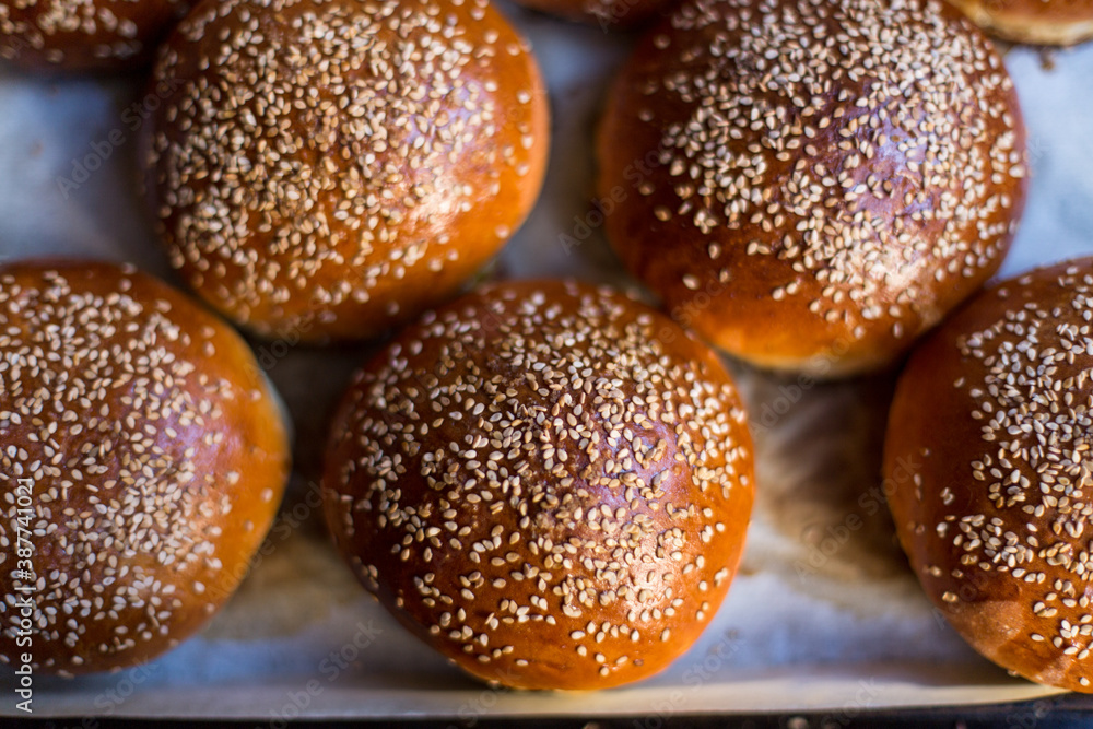 close up of burger buns with sesame seeds close up of burger buns with sesame seeds