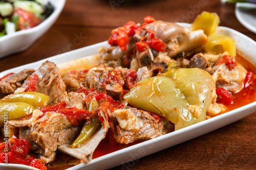 stewed lamb on the bone with vegetables on wooden deskKhashlama is popular Armenian dish, which is prepared from beef with vegetables. Khashlama in the plate.  caucasian food photo