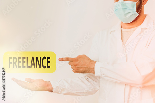 Word writing text Freelance. Business photo showcasing an individual who pursues a profession without a longterm commitment Displaying Empty Sticker Paper Accessories Smartphone With Medical Gloves On