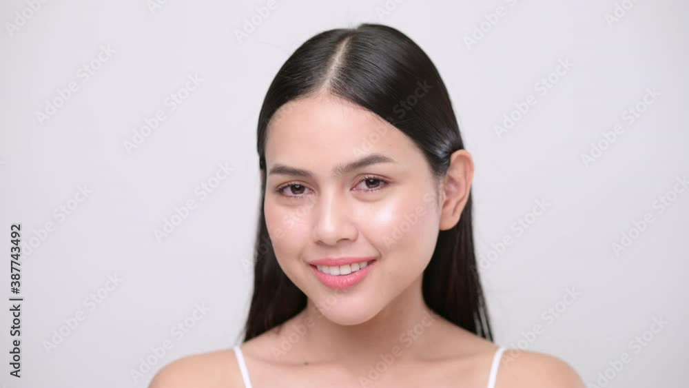 Portrait of young beautiful woman with smooth healthy skin, she gently touches her face with her fingers on white grey background , Skincare concept Portrait of young beautiful woman with smooth healthy skin, she gently touches her face with her fingers on white grey background , Skincare concept