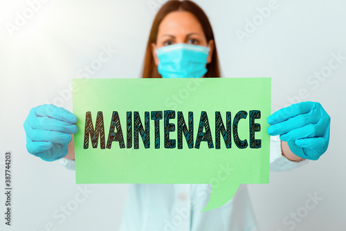 Handwriting text Maintenance. Conceptual photo the process of maintaining or preserving someone or something Laboratory technician featuring empty sticker paper accessories smartphone photo