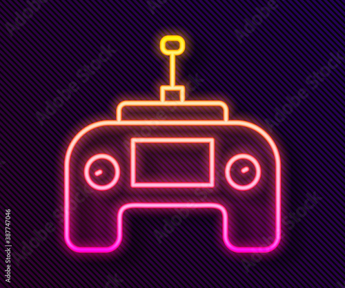 Glowing neon line Drone radio remote control transmitter icon isolated on black background. Vector.