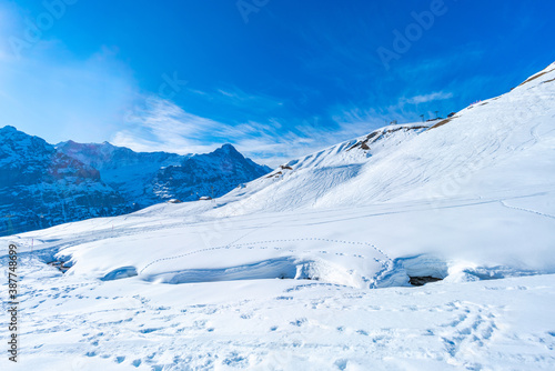 Winter landscape with snow covered peaks seen from the First mountain in Swiss Alps in Grindelwald  Switzerland