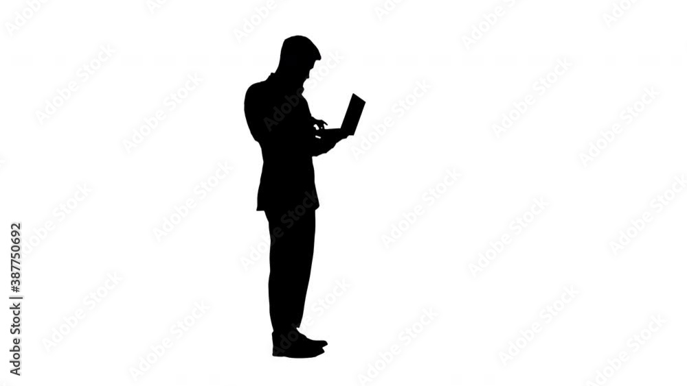 Handsome businessman standing and working on laptop, Alpha Channel Handsome businessman standing and working on laptop, Alpha Channel