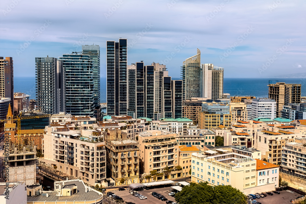 Naklejka premium Vibrant urban skyline of Beirut, a Mediterranean coastal city featuring modern high-rise buildings, luxury apartments, and commercial towers contrasting with Beirut's classical buildings