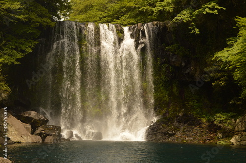 Fototapeta Naklejka Na Ścianę i Meble -  Exploring the beautiful waterfalls and nature of Jeju Island in South Korea