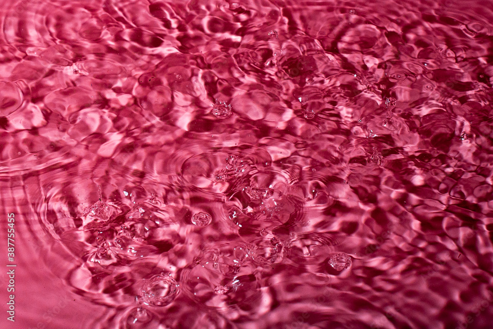 splash of water on a red background. Abstract wallpaper splash of water on a red background. Abstract wallpaper