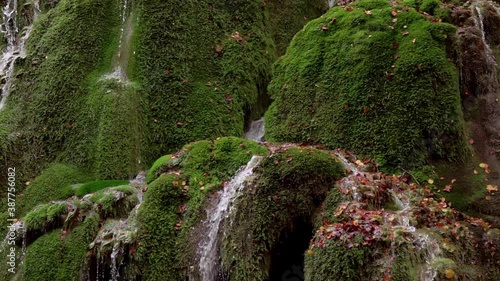 The unique beautiful Bigar waterfall full of green moss, Bozovici, Caras-Severin, Romania. Slow motion photo