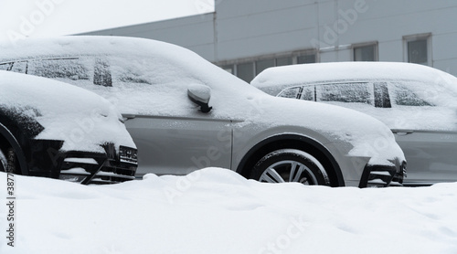 Parked cars covered with snow. Winter season