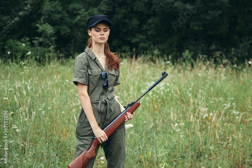 Woman woman holding a gun in her hands closed eyes hunting lifestyle fresh air