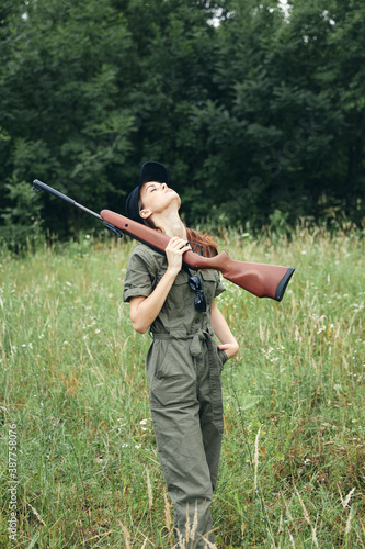 Military woman Look up shotgun fresh air nature black cap 