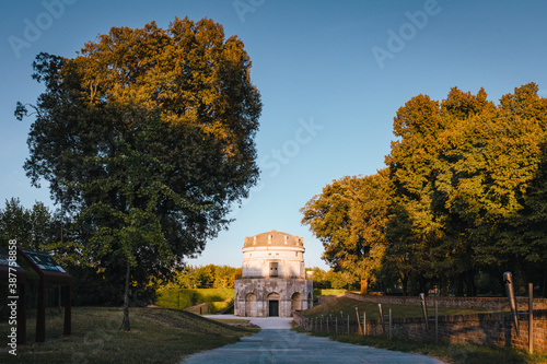 Fototapeta Naklejka Na Ścianę i Meble -  Ravenna / Italy - August 2020: Mausoleum of Theodoric at sunset, blue sky with clouds