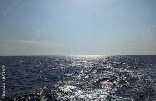 View from board of cutter with blue water and sea foam