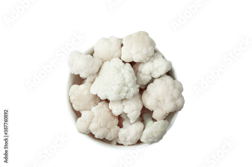 Frozen cauliflower florets in a bowl isolated on white backgroung, top view