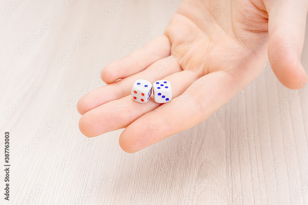 Man holds playing dice. Space for text