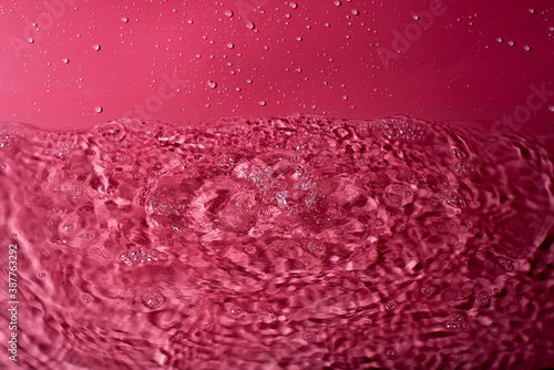 splash of water on a red background. Abstract wallpaper
