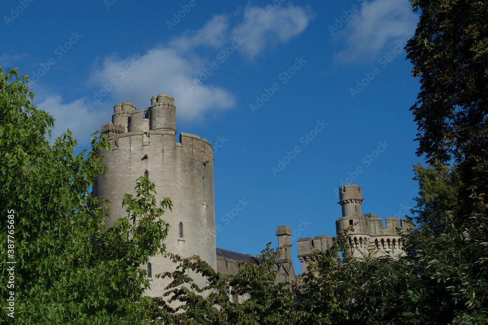 Turrets of an ancient traditional castle seen through trees