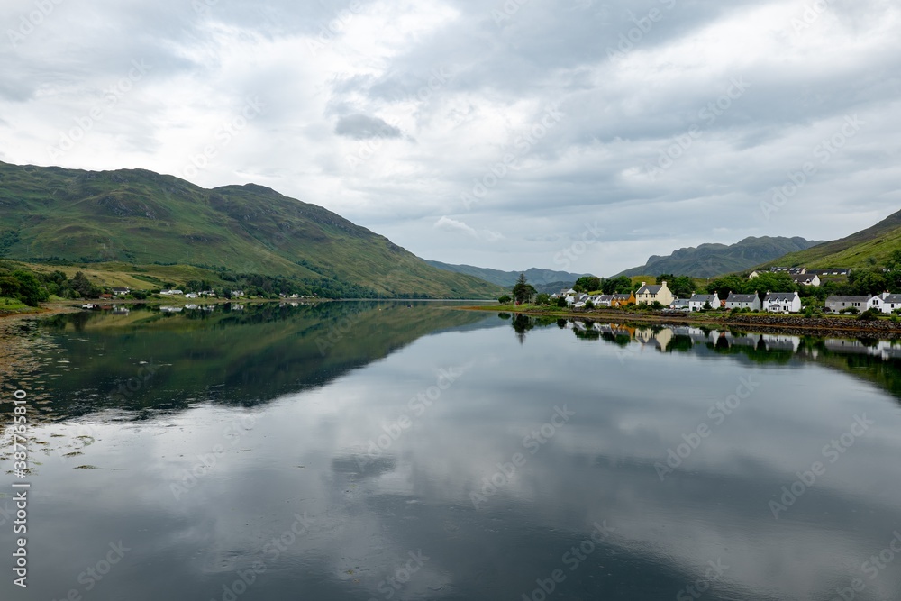 Obraz premium Landscape with waters of Loch Duich with a town of Dornie, Scotland in Scottish overcast weather