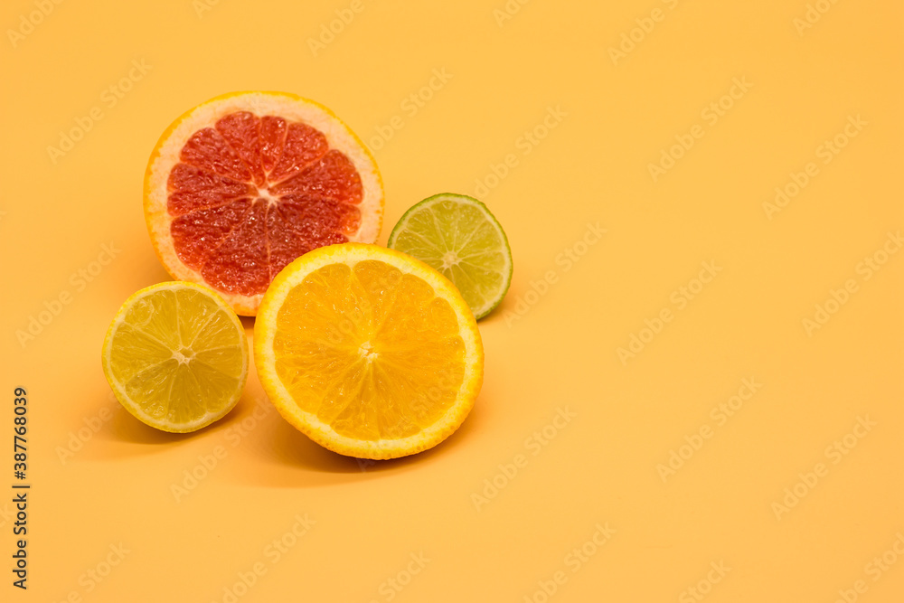 various citrus slices of orange lime lemon and grapefruit arranged on colorful background abstract wallpaper with copy space various citrus slices of orange lime lemon and grapefruit arranged on colorful background abstract wallpaper with copy space