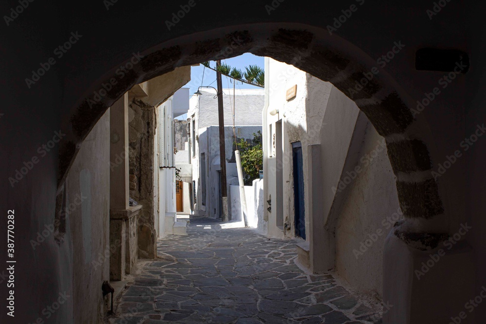 Narrow alley under a bridge in Naxos island, Greece