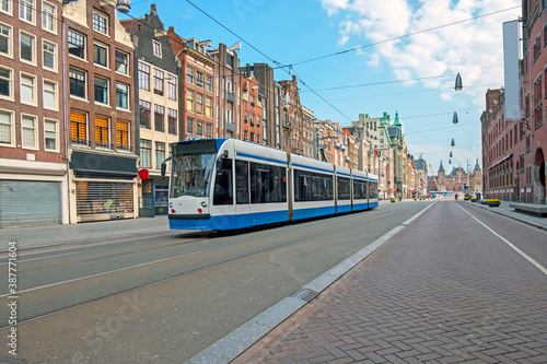 Tram driving at Damrak in Amsterdam the Netherlands