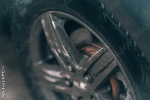 Dirty car wheel. Blured defocused car wheel background