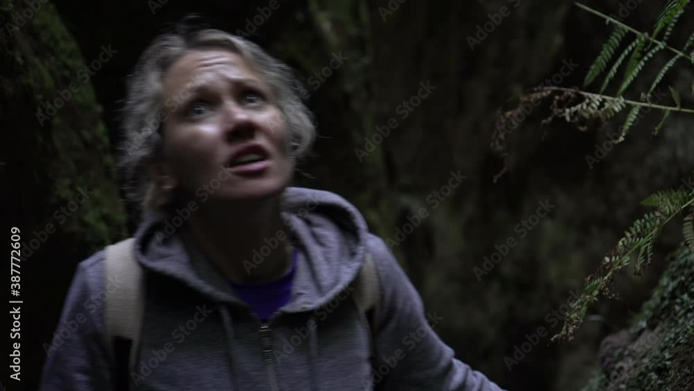 Frightened woman in a dark forest. The woman runs away from danger and gets lost in the forest Frightened woman in a dark forest. The woman runs away from danger and gets lost in the forest